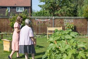 Mary Dutton walks through the garden in Brinnington